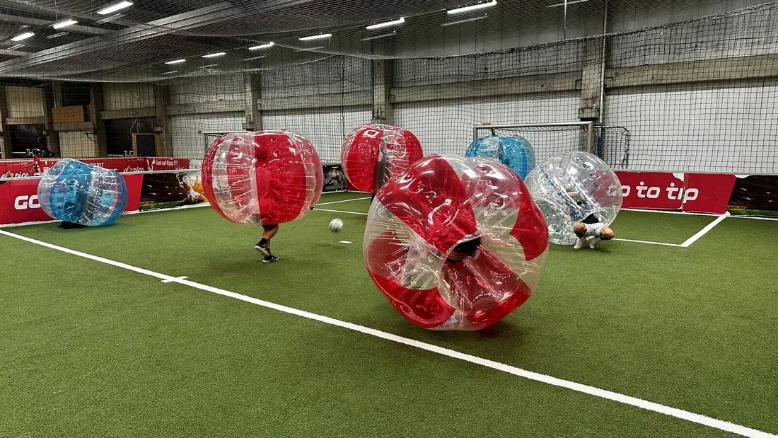 Firmengruppe beim Bubble Soccer, betreut von einem Eventleiter